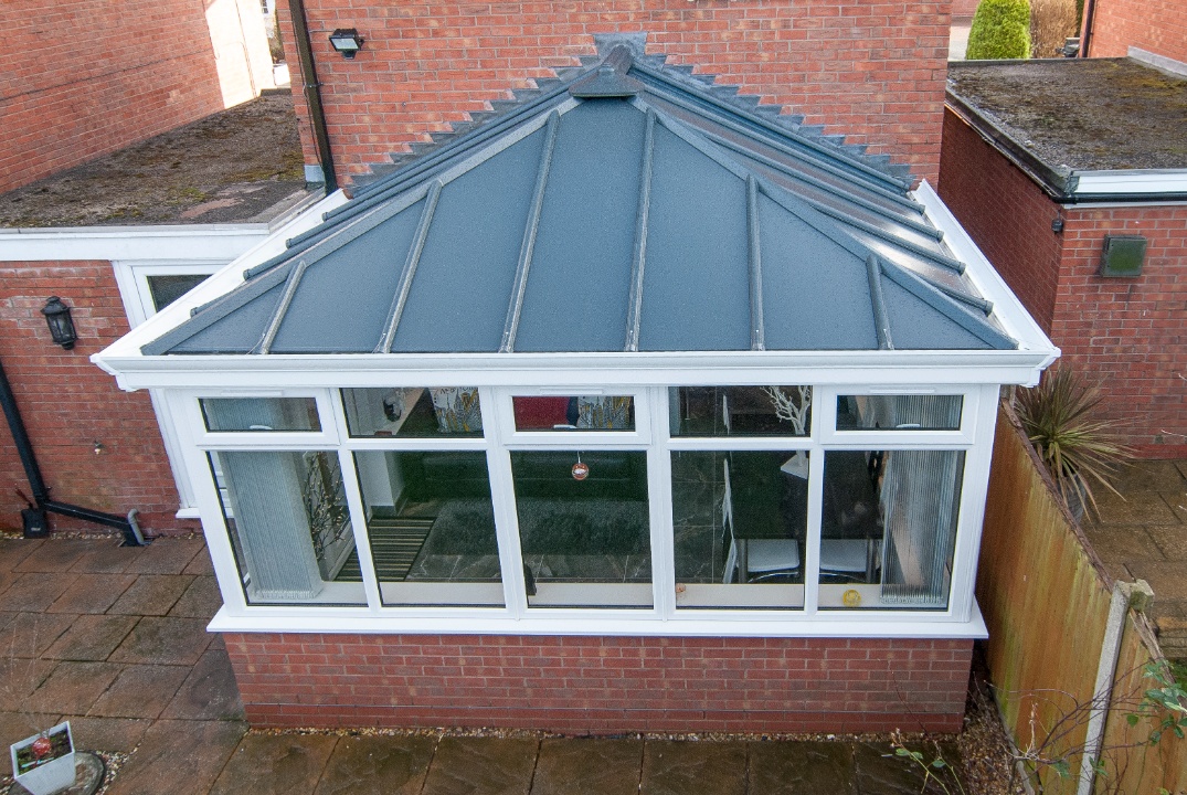 An aerial view of an Livinroof hybrid conservatory, showcasing its innovative combination of solid panels and glazed sections for thermal efficiency and natural light.